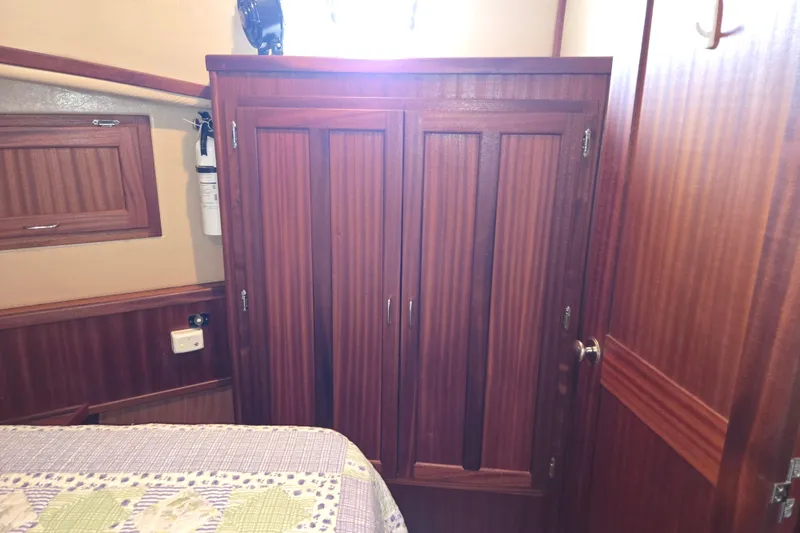 Slide: The Image of Interior of 2009 American Tug 34 Rare Flybridge Model with wooden cabinetry and bed. - 49