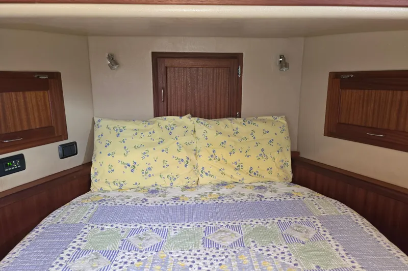 Slide: The Image of Cozy cabin interior of 2009 American Tug 34 with floral bedding and wooden accents. - 51