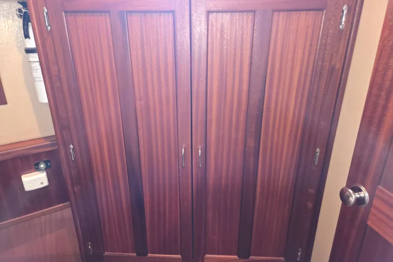 Slide: The Image of Wooden cabinet doors inside a 2009 American Tug 34 Rare Flybridge Model. - 56