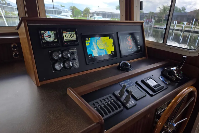 Slide: The Image of American Tug 34 Rare Flybridge Model 2009 helm with navigation instruments and controls. - 6