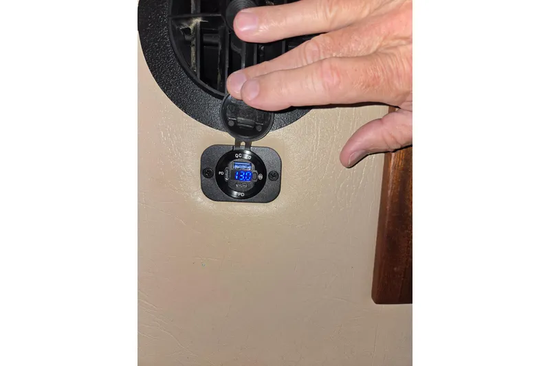 Slide: The Image of Hand adjusting voltage display on 2009 American Tug 34 Rare Flybridge Model. - 60