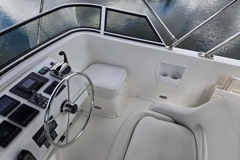 Slide: The Image of Flybridge helm of 2009 American Tug 34, featuring steering wheel and control panel. - 74