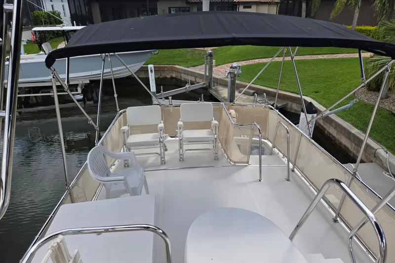 Slide: The Image of 2009 American Tug 34 Rare Flybridge Model with seating and canopy in marina setting. - 76
