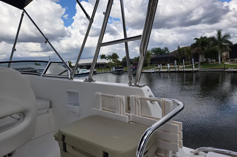 Slide: The Image of 2009 American Tug 34 Rare Flybridge Model, docked with scenic waterfront view. - 77