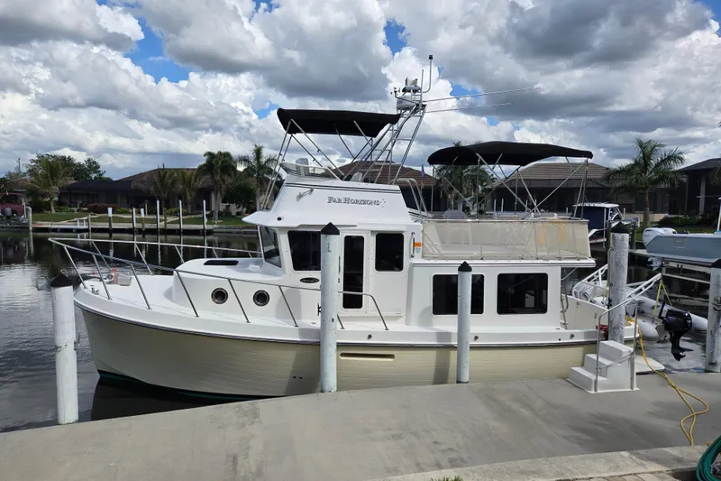 Slide: The Image of 2009 American Tug 34 Rare Flybridge Model docked under cloudy sky. - 78