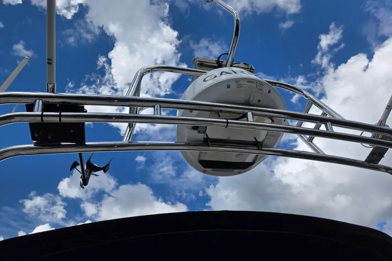 Slide: The Image of 2009 American Tug 34 Rare Flybridge Model against a vibrant blue sky with clouds. - 79