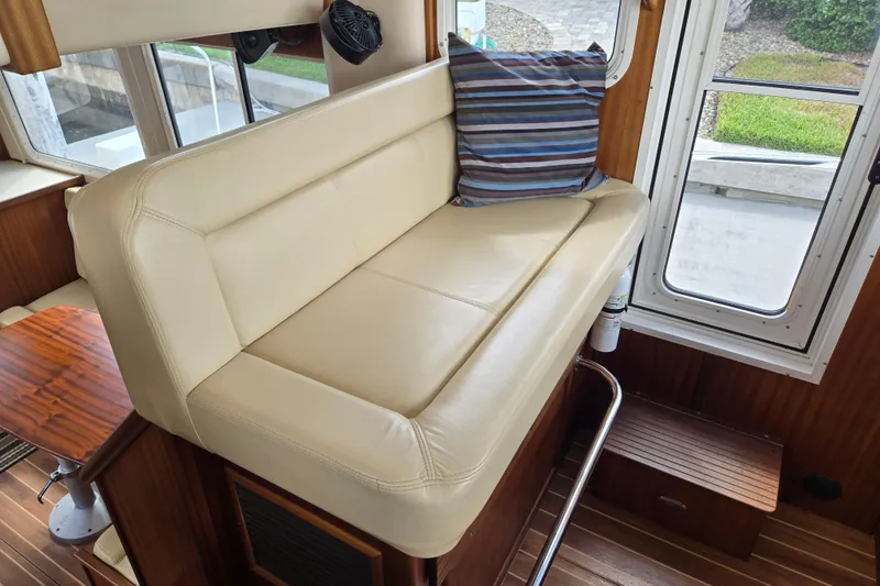 Slide: The Image of Luxurious interior seating of 2009 American Tug 34 Rare Flybridge Model with striped cushion. - 8