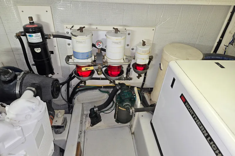 Slide: The Image of Engine room of 2009 American Tug 34 Rare Flybridge Model with fuel filters and Northern Lights generator. - 89