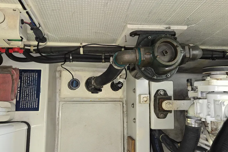 Slide: The Image of Engine room of 2009 American Tug 34 Rare Flybridge Model, showcasing mechanical components and wiring. - 91