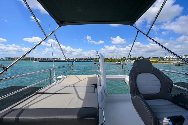 Slide: The Image of 2022 Jeanneau NC Weekender 1095 Flybridge with scenic waterfront view. - 11