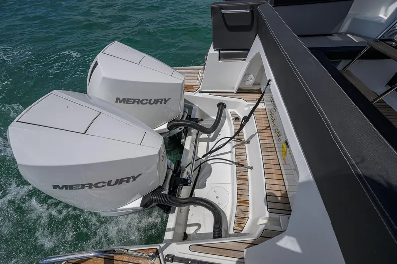 Slide: The Image of 2022 Jeanneau NC Weekender 1095 Fly with dual Mercury outboard engines on teak deck. - 12