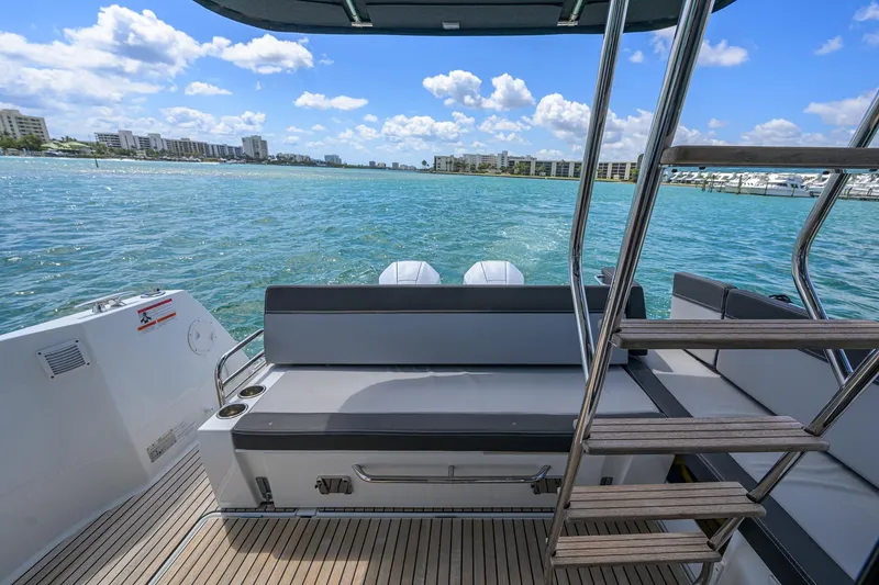 Slide: The Image of 2022 Jeanneau NC Weekender 1095 Fly, rear view, ocean backdrop, sunny day. - 13