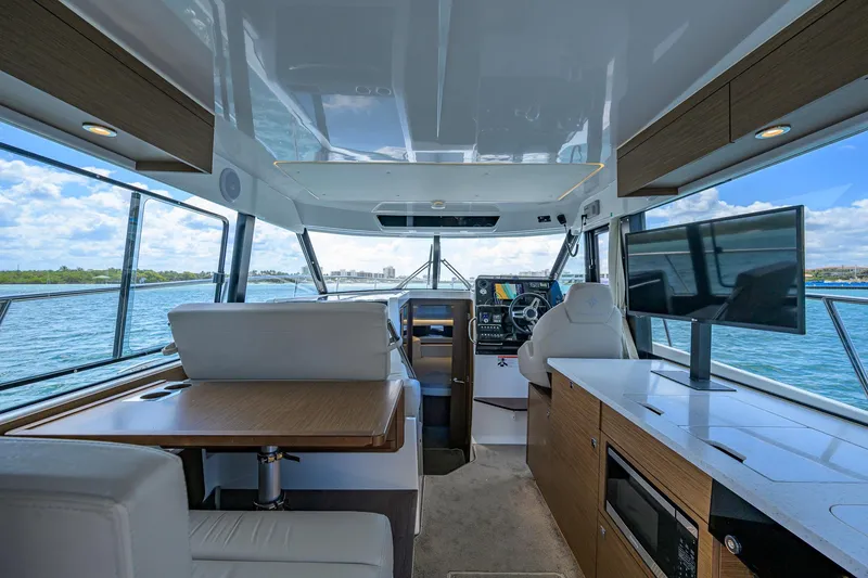 Slide: The Image of Interior of 2022 Jeanneau NC Weekender 1095 Fly, featuring modern helm and seating area. - 19