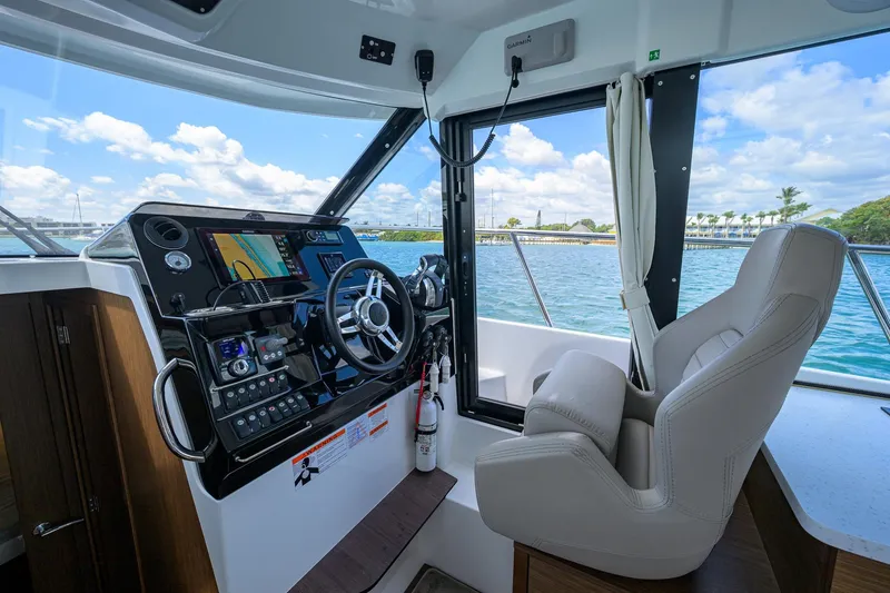 Slide: The Image of Interior helm of 2022 Jeanneau NC Weekender 1095 Fly with modern controls and scenic view. - 20