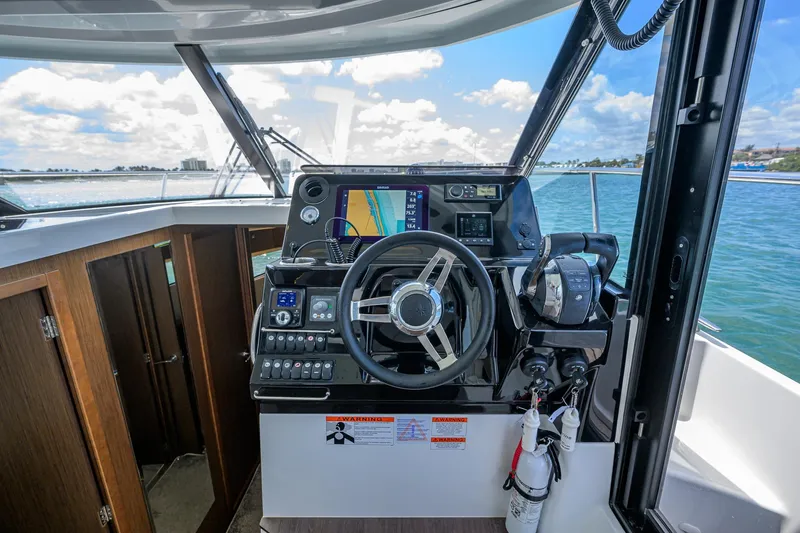 Slide: The Image of Helm of 2022 Jeanneau NC Weekender 1095 Fly with navigation equipment and controls. - 21