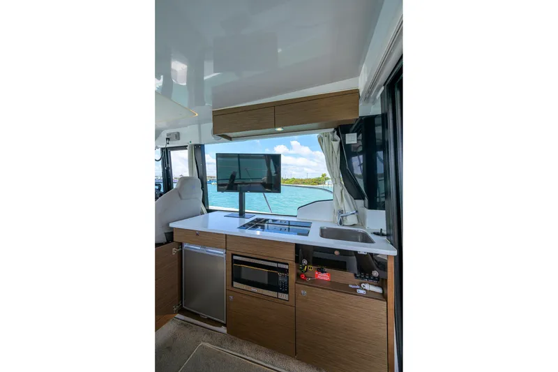 Slide: The Image of Interior of 2022 Jeanneau NC Weekender 1095 Fly with modern kitchen and scenic view. - 23