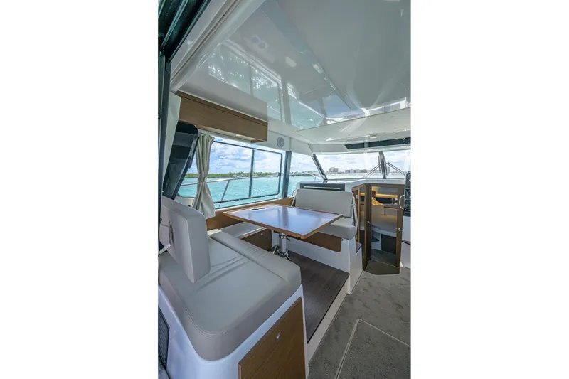 Slide: The Image of Interior of 2022 Jeanneau NC Weekender 1095 Fly, featuring seating and dining area. - 25