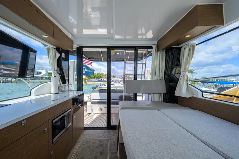 Slide: The Image of Interior of 2022 Jeanneau NC Weekender 1095 Fly, featuring modern kitchen and seating area. - 27