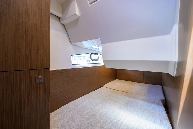 Slide: The Image of Interior cabin of 2022 Jeanneau NC Weekender 1095 Fly, featuring a cozy bed and wooden accents. - 32