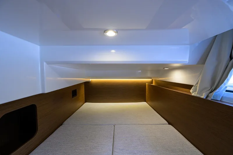 Slide: The Image of Interior cabin of 2022 Jeanneau NC Weekender 1095 Fly, featuring cozy bedding and ambient lighting. - 35