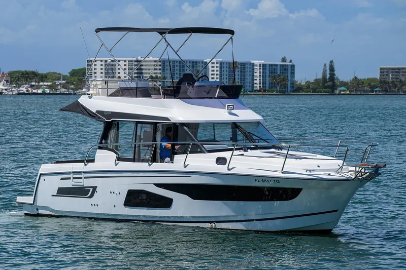 Slide: The Image of 2022 Jeanneau NC Weekender 1095 Fly cruising on a sunny day near coastal buildings. - 37