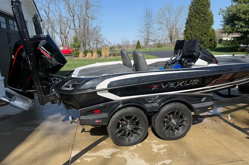 The Image of 2024 Vexus VXs20 boat on trailer, featuring sleek black design and powerful Mercury Pro XS engine. - 1