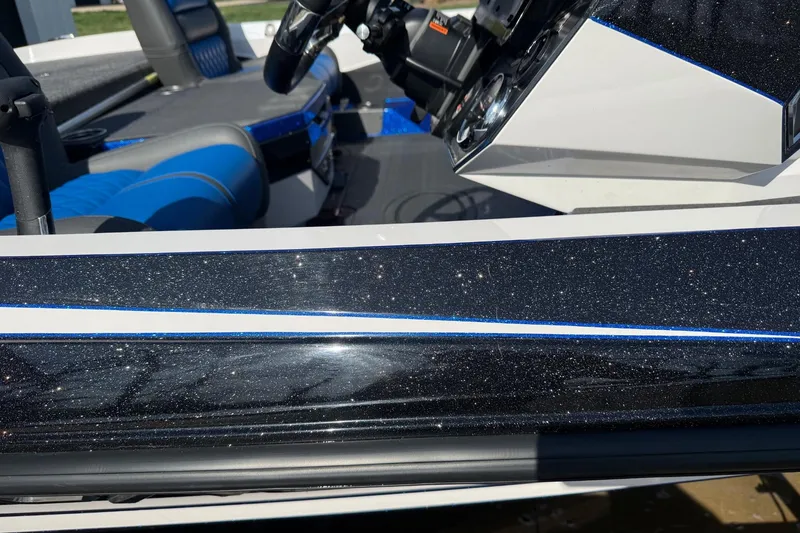 Slide: The Image of 2024 Vexus VXs20 boat interior with sparkling black and blue accents. - 12