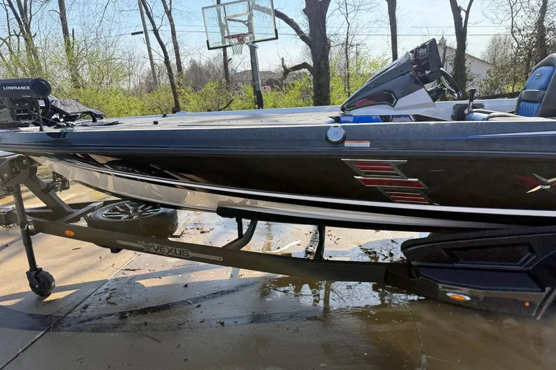 Slide: The Image of 2024 Vexus VXs20 boat on trailer, parked outdoors near basketball hoop. - 4