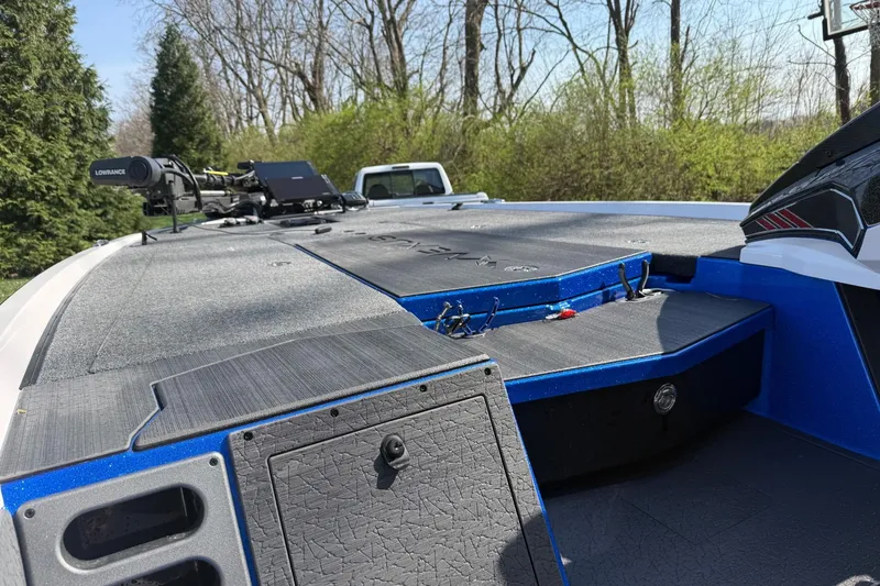 Slide: The Image of 2024 Vexus VXs20 boat deck with Lowrance equipment, surrounded by trees. - 6