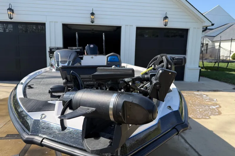 Slide: The Image of 2024 Vexus VXs20 boat with Garmin equipment, parked in front of a garage. - 9