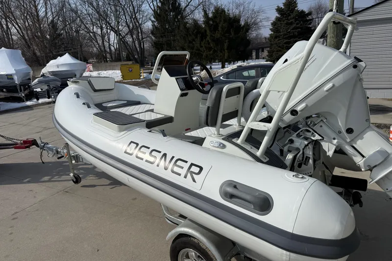 Slide: The Image of Inflatable Desner SP 330 boat, 2026 model, parked outdoors on a trailer. - 10