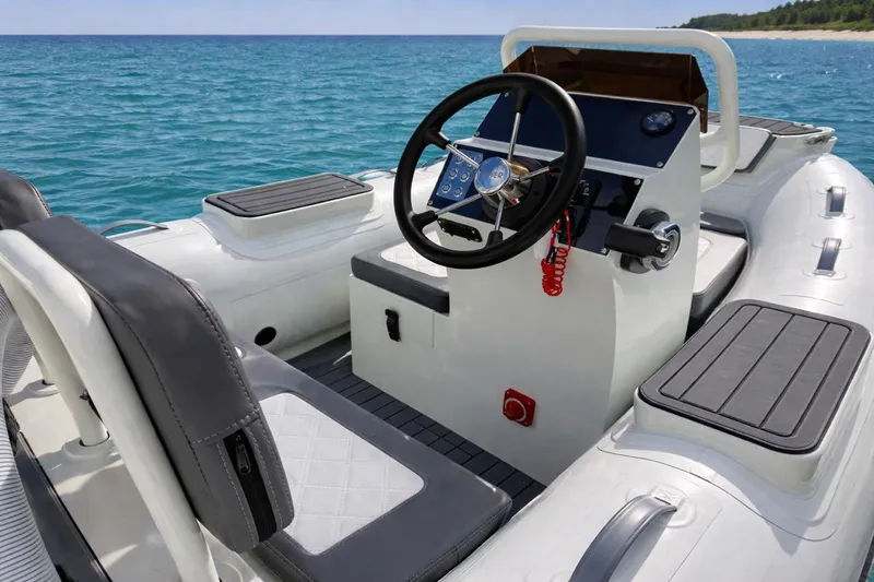 Slide: The Image of 2026 Desner SP 330 inflatable boat interior with steering wheel, seats, and ocean backdrop. - 5