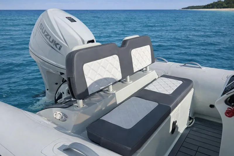 Slide: The Image of Inflatable boat with Suzuki motor, featuring Desner SP 330 model, 2026, on clear blue water. - 6