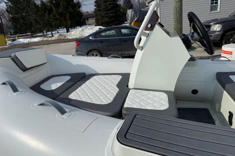 Slide: The Image of Desner SP 330 boat interior with cushioned seating, steering wheel, and modern design, 2026 model. - 7