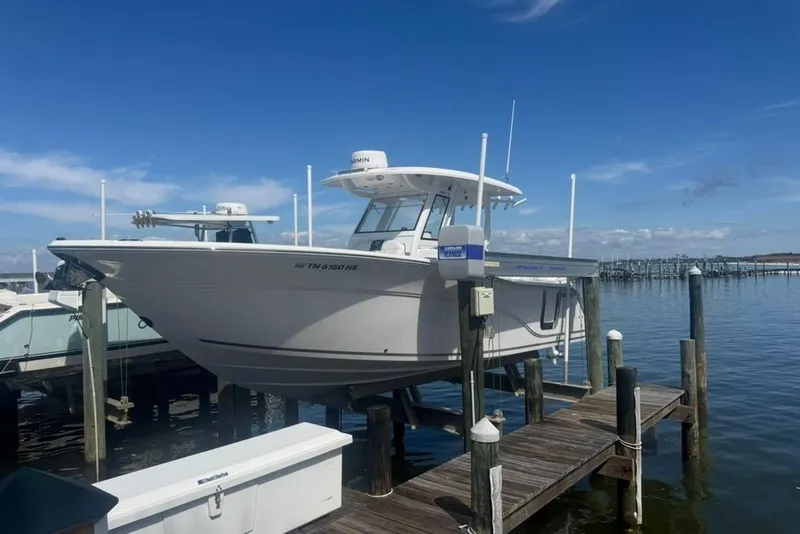 The Image of 2024 Sea Fox 288 Commander boat docked at a marina under a clear blue sky. - 1
