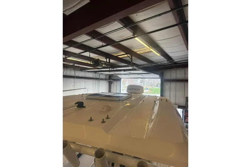 Slide: The Image of 2024 Sea Fox 288 Commander boat roof with Garmin equipment in a garage. - 12