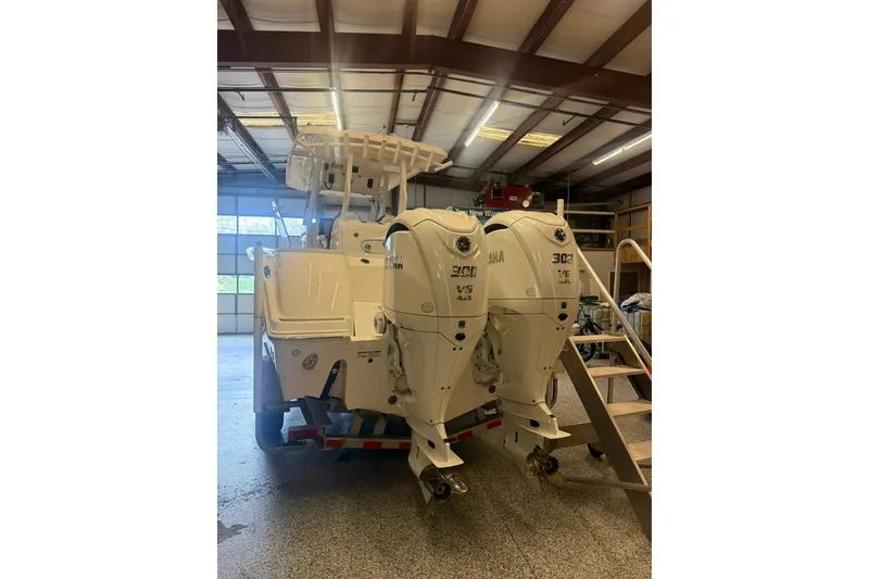 Slide: The Image of 2024 Sea Fox 288 Commander with twin Yamaha 300 engines in a garage. - 3