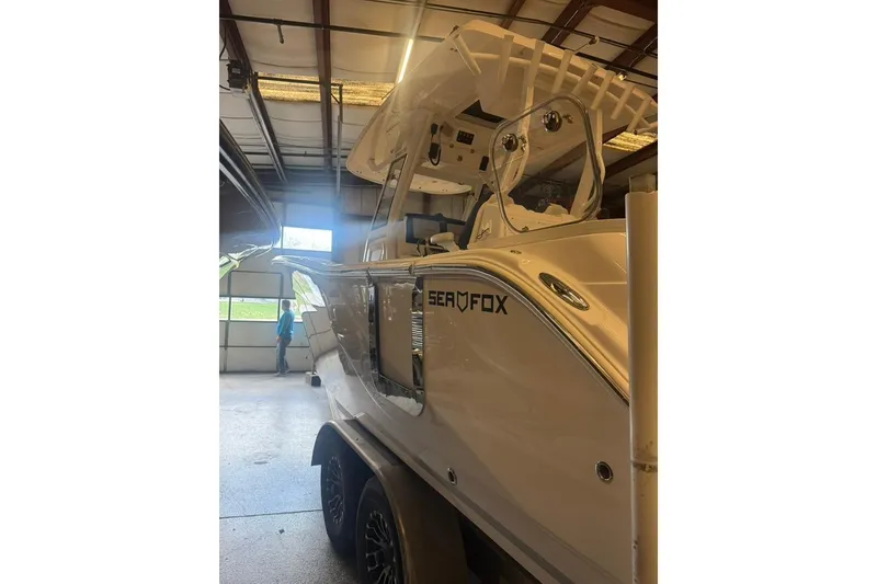 Slide: The Image of 2024 Sea Fox 288 Commander boat in a garage, side view. - 4