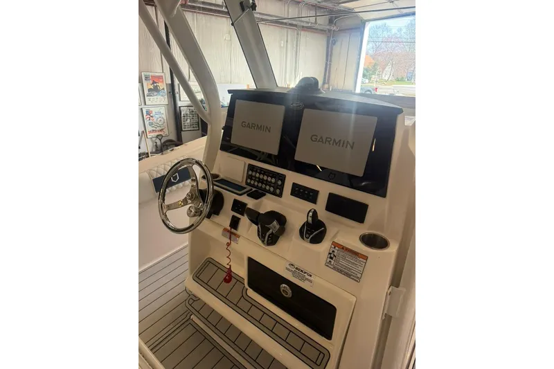 Slide: The Image of 2024 Sea Fox 288 Commander boat dashboard with Garmin navigation displays. - 8