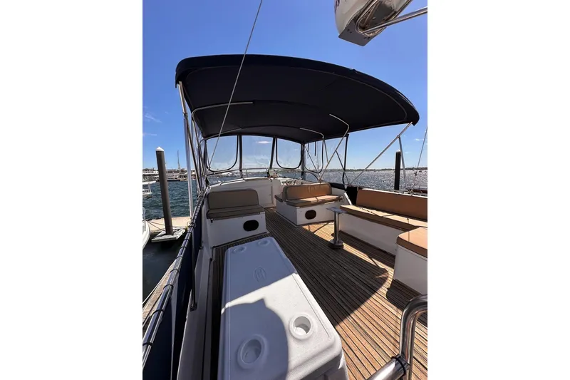 Slide: The Image of 1994 Grand Banks 42 Classic yacht deck with seating, canopy, and ocean view. - 12