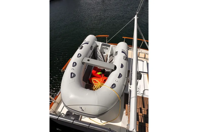 Slide: The Image of Inflatable dinghy on 1994 Grand Banks 42 Classic yacht, docked on calm water. - 17