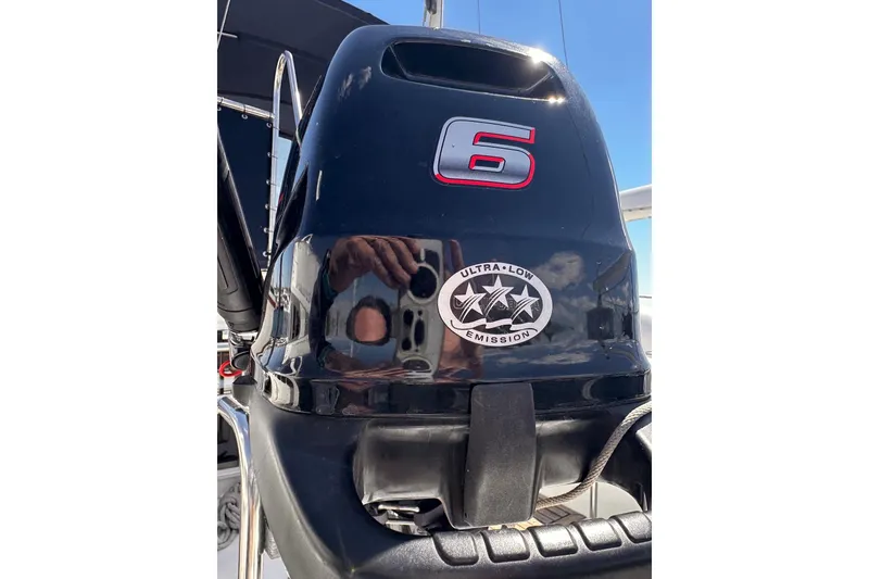 Slide: The Image of Outboard motor with "6" and "Ultra-Low Emission" label on a 1994 Grand Banks 42 Classic. - 18