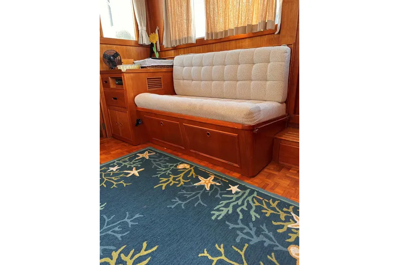 Slide: The Image of Interior of 1994 Grand Banks 42 Classic with cushioned seating and nautical-themed rug. - 20