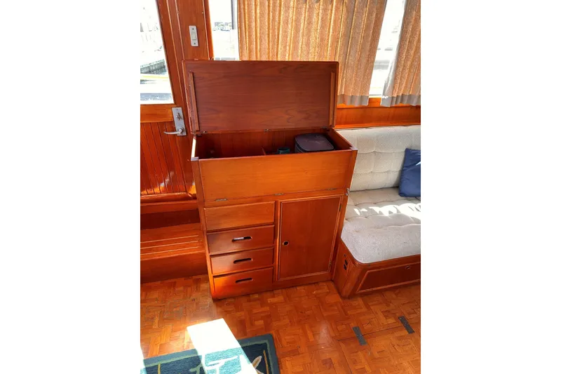 Slide: The Image of Wooden interior of 1994 Grand Banks 42 Classic yacht with storage cabinet and cushioned seating. - 21