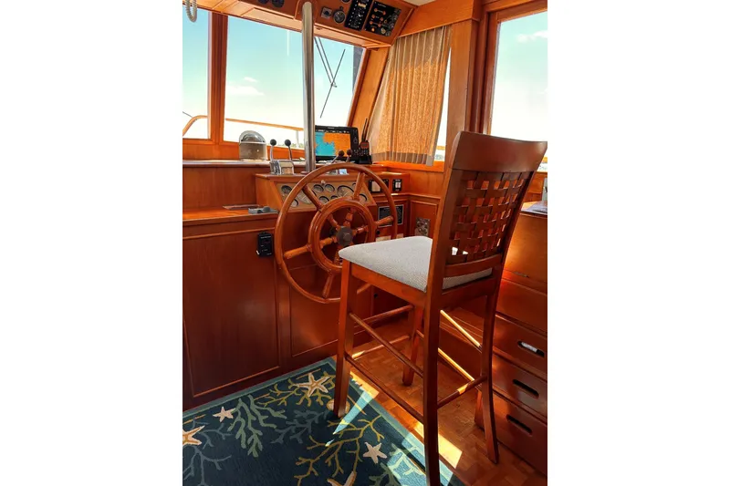 Slide: The Image of Helm of 1994 Grand Banks 42 Classic yacht with wooden steering wheel and chair. - 22