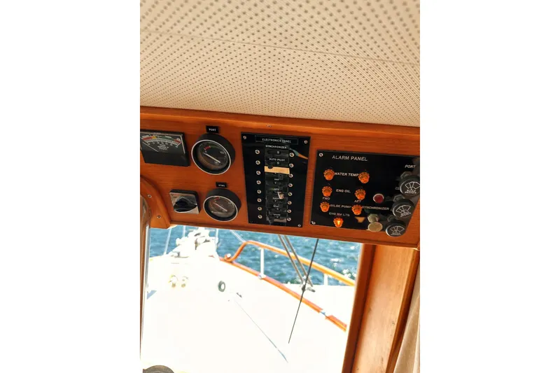 Slide: The Image of Control panel of a 1994 Grand Banks 42 Classic yacht, featuring gauges and alarm indicators. - 25
