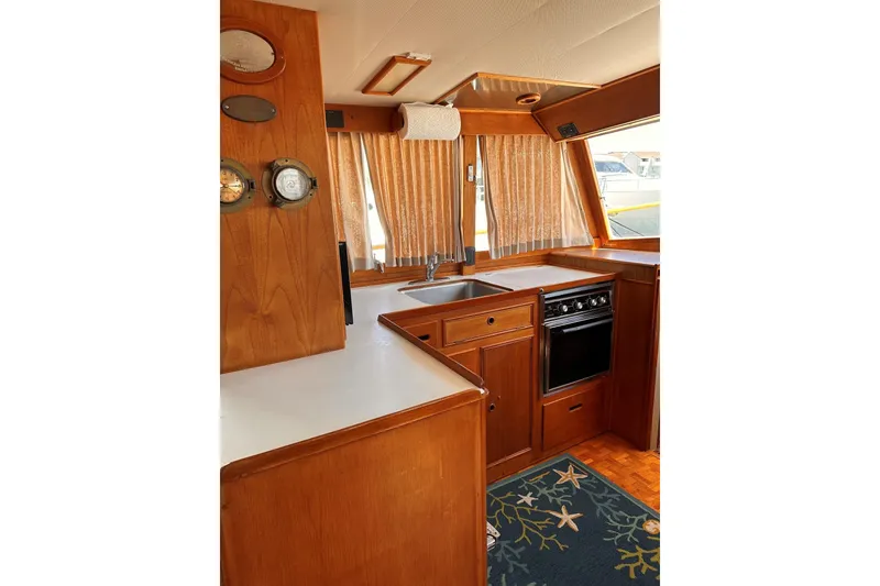 Slide: The Image of Interior of 1994 Grand Banks 42 Classic yacht kitchen with wood cabinetry and nautical decor. - 26