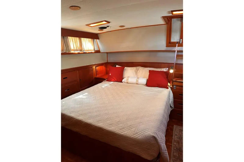 Slide: The Image of Cozy bedroom interior of 1994 Grand Banks 42 Classic yacht with wooden cabinetry. - 27