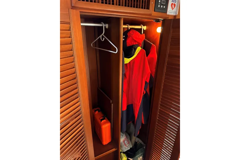 Slide: The Image of Wooden closet on 1994 Grand Banks 42 Classic yacht with jackets and safety equipment. - 30