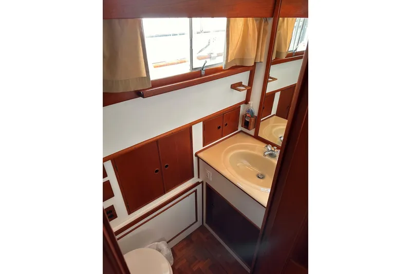 Slide: The Image of Bathroom interior of 1994 Grand Banks 42 Classic yacht with wooden cabinetry and sink. - 31